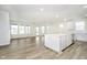 Open-concept kitchen flowing to a spacious living area, with an island and stainless steel appliances at 5661 Stetson Dr, Whitestown, IN 46052