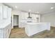 Bright kitchen features white cabinetry, a large island, stainless steel appliances, and walk-in pantry at 5661 Stetson Dr, Whitestown, IN 46052