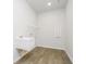 Functional laundry room with utility sink, hanging rack, and durable flooring at 5661 Stetson Dr, Whitestown, IN 46052