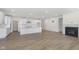 Open-concept floor plan with a kitchen, living room, and fireplace, perfect for entertaining at 5661 Stetson Dr, Whitestown, IN 46052