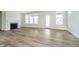 Bright living room with hardwood flooring, a fireplace, and large windows at 5661 Stetson Dr, Whitestown, IN 46052