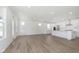 Bright living room features hardwood floors, recessed lighting, and an open layout to the kitchen with white cabinets at 5661 Stetson Dr, Whitestown, IN 46052