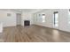 Spacious living room featuring a cozy fireplace, natural light, and a walk out patio at 5661 Stetson Dr, Whitestown, IN 46052