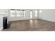 Bright living room featuring a modern fireplace, large windows, and stylish flooring at 5661 Stetson Dr, Whitestown, IN 46052