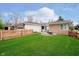 Spacious backyard with green grass, fire pit, and wooden fence offering privacy at 5715 N Meridian St, Indianapolis, IN 46208