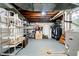 Basement with storage shelving, furnace, and washer/dryer hookups at 5715 N Meridian St, Indianapolis, IN 46208