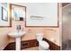 Charming bathroom with period tile, a pedestal sink, and a glass-enclosed shower maintains classic appeal at 5715 N Meridian St, Indianapolis, IN 46208