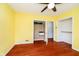 Bright bedroom with yellow walls, wood floors, and a closet provides a spacious and cheerful atmosphere at 5715 N Meridian St, Indianapolis, IN 46208