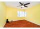 Sun-filled bedroom with bright yellow walls, hardwood floors, and a large window provides a cheerful space at 5715 N Meridian St, Indianapolis, IN 46208