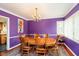 Formal dining room with wood table, chairs, chandelier, and purple walls at 5715 N Meridian St, Indianapolis, IN 46208