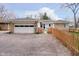 Exterior view of home showing driveway, garage, and fenced yard at 5715 N Meridian St, Indianapolis, IN 46208