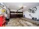 Spacious garage with overhead door, bike rack and lawn equipment at 5715 N Meridian St, Indianapolis, IN 46208