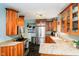 Bright kitchen features custom wood cabinets, granite countertops, black tile flooring, and stainless steel appliances at 5715 N Meridian St, Indianapolis, IN 46208