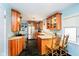 Well-lit kitchen features custom wood cabinets, granite countertops, black tile flooring, and modern stainless steel appliances at 5715 N Meridian St, Indianapolis, IN 46208