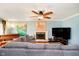 Cozy living room with fireplace, piano, and comfortable gray sectional sofa at 5715 N Meridian St, Indianapolis, IN 46208