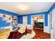Bright living room with blue paneled walls, hardwood floors, and built-in bookshelves offers a cozy atmosphere at 5715 N Meridian St, Indianapolis, IN 46208