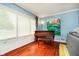 Bright living room with hardwood floors, piano, and large windows at 5715 N Meridian St, Indianapolis, IN 46208