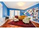 Bright room with blue walls, floral seating, and a collection of bookshelves at 5715 N Meridian St, Indianapolis, IN 46208