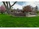 Backyard featuring a wooden deck, perfect for relaxing with outdoor furniture and mature trees at 601 E 95Th St, Indianapolis, IN 46240