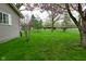 Lush green backyard featuring mature trees and a well-maintained lawn, offering a serene outdoor space at 601 E 95Th St, Indianapolis, IN 46240