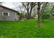 Spacious backyard with green grass and a home exterior, providing ample space for outdoor activities at 601 E 95Th St, Indianapolis, IN 46240