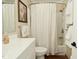 Bathroom with shower and tub combination, decorative shower curtain, and classic vanity at 601 E 95Th St, Indianapolis, IN 46240