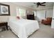 Bright bedroom features a queen-sized bed and a comfortable armchair, perfect for relaxation at 601 E 95Th St, Indianapolis, IN 46240