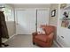 Bedroom with sliding closet doors and comfortable sitting area at 601 E 95Th St, Indianapolis, IN 46240