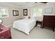 Bright bedroom with two windows, dressers and bedside tables at 601 E 95Th St, Indianapolis, IN 46240