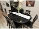 The dining room features a sleek black table, decorative center piece, and plenty of seating at 601 E 95Th St, Indianapolis, IN 46240