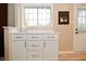 Eat-in kitchen features white cabinetry, stainless hardware, and a view to the backyard at 601 E 95Th St, Indianapolis, IN 46240