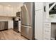Stainless steel refrigerator and appliances with white cabinets and countertops at 601 E 95Th St, Indianapolis, IN 46240