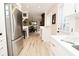 Open concept kitchen and dining area with stainless steel refrigerator, hardwood floors, and white cabinetry at 601 E 95Th St, Indianapolis, IN 46240