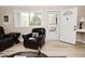 Bright living room boasting new light floors and lots of space to relax with a window view of the exterior porch at 601 E 95Th St, Indianapolis, IN 46240