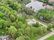 Aerial view of a home surrounded by lush trees and a tranquil pond, creating a private oasis at 6113 N 250 E, Greenfield, IN 46140