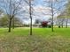 Lush backyard with mature trees offering privacy and shade at 6113 N 250 E, Greenfield, IN 46140