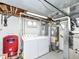 Basement laundry room with washer, dryer, and water heater at 6113 N 250 E, Greenfield, IN 46140