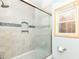 This bathroom features a shower, tile walls, and a window at 6113 N 250 E, Greenfield, IN 46140