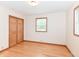 Neutral bedroom featuring two windows, hardwood floors, painted trim and a closet at 6113 N 250 E, Greenfield, IN 46140