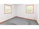 This bedroom has two windows, neutral paint, and gray carpet at 6113 N 250 E, Greenfield, IN 46140
