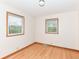 Neutral bedroom featuring two windows and hardwood floors at 6113 N 250 E, Greenfield, IN 46140