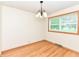 Sunlit dining space boasts hardwood floors and a large window with a picturesque view at 6113 N 250 E, Greenfield, IN 46140