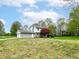 Two-story home with attached garage, mature trees, and sprawling front yard at 6113 N 250 E, Greenfield, IN 46140