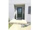 Charming front entrance with a glass door, decorative plants, and outdoor lighting at 6113 N 250 E, Greenfield, IN 46140