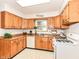 Well-lit kitchen featuring warm wood cabinetry and modern appliances for efficient meal preparation at 6113 N 250 E, Greenfield, IN 46140