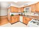 Charming kitchen with oak cabinets, updated appliances, and a view from the window at 6113 N 250 E, Greenfield, IN 46140