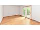Spacious living room with hardwood floors and access to a sunny outdoor patio at 6113 N 250 E, Greenfield, IN 46140