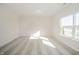 Bright empty room featuring large window, carpet flooring, and white walls at 6204 Fairview Dr, McCordsville, IN 46055