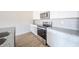 Kitchen features stainless steel appliances, granite countertops, white cabinets, and hardwood floors at 6204 Fairview Dr, McCordsville, IN 46055