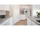 Bright modern kitchen features granite countertops, stainless steel appliances, and white cabinetry at 6204 Fairview Dr, McCordsville, IN 46055